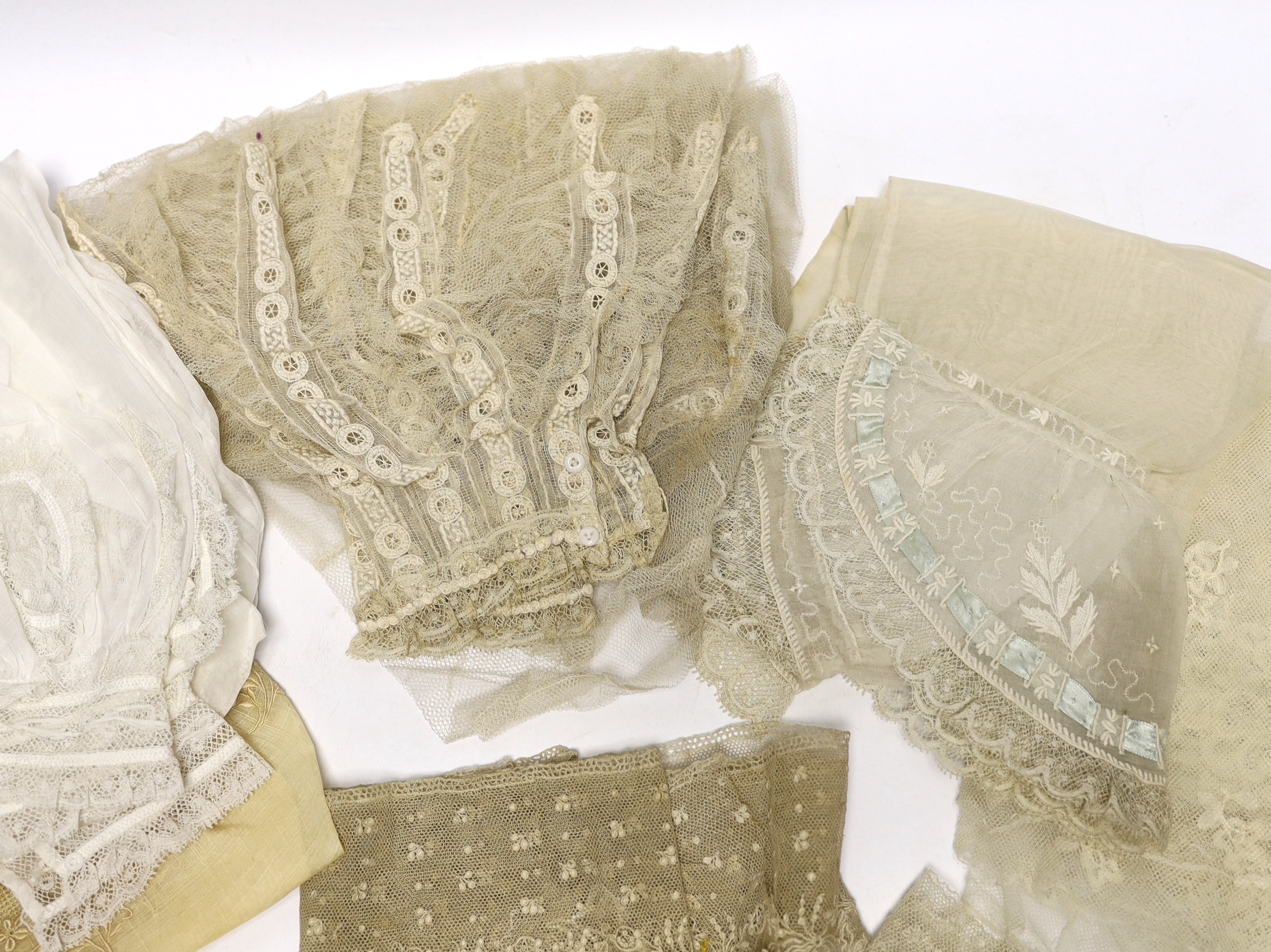 A collection of mostly 19th century French and English needle and bobbin lace trimmings, white worked sleeves, a black silk stole and black lace trimmings etc